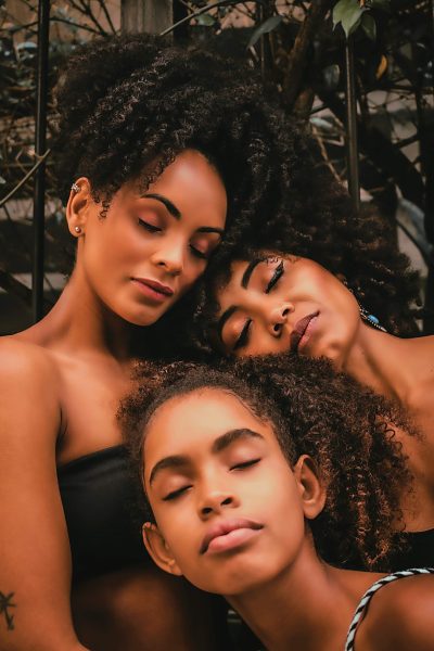 Three women together in a family, representing a healthy relationship after healing from generational, religious, and familial trauma